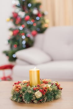 Candle and wreath on table for christmas at home in the living room